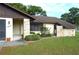 Inviting home entrance with stone accents, well-maintained landscaping, and a cozy front porch at 13425 Bonita Ave, Spring Hill, FL 34609