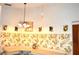 Cozy eat-in kitchen featuring vintage fruit motif wallpaper and lots of counter space at 13425 Bonita Ave, Spring Hill, FL 34609