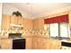 Bright kitchen featuring wood cabinets and modern appliances at 13425 Bonita Ave, Spring Hill, FL 34609
