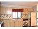 Bright eat-in kitchen featuring wood cabinets and modern appliances at 13425 Bonita Ave, Spring Hill, FL 34609