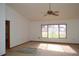 Living room with ceiling fan and large window providing plenty of natural light at 13425 Bonita Ave, Spring Hill, FL 34609