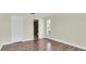 Bedroom with en suite bathroom, wood-look flooring, and natural light at 1402 Tallahassee Dr, Tarpon Springs, FL 34689