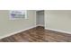 Bedroom featuring wood-look flooring, a window, and a closet at 1402 Tallahassee Dr, Tarpon Springs, FL 34689
