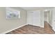 Bedroom featuring wood-look flooring and a closet with sliding doors at 1402 Tallahassee Dr, Tarpon Springs, FL 34689