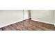 Bedroom showcasing stylish wood-look flooring and a white painted door at 1402 Tallahassee Dr, Tarpon Springs, FL 34689