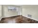 Bedroom with wood-look flooring and a window for natural light at 1402 Tallahassee Dr, Tarpon Springs, FL 34689