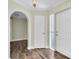 Bright entryway featuring an arched doorway and wood-look floors at 1402 Tallahassee Dr, Tarpon Springs, FL 34689