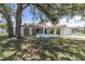 Charming home featuring an arched entryway and stone accents at 1402 Tallahassee Dr, Tarpon Springs, FL 34689