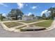 Exterior view of the home from the street, showcasing the yard and surrounding neighborhood at 1402 Tallahassee Dr, Tarpon Springs, FL 34689