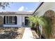 Close-up of a front entrance boasting a decorative stone feature and stylish black accents at 1402 Tallahassee Dr, Tarpon Springs, FL 34689