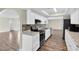 Modern kitchen with white cabinetry, granite countertops, and black appliances at 1402 Tallahassee Dr, Tarpon Springs, FL 34689