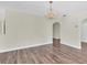 Open-concept living room featuring wood-look flooring and decorative chandelier at 1402 Tallahassee Dr, Tarpon Springs, FL 34689