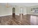 Bright living room with hardwood floors and arches that add architectural charm at 1402 Tallahassee Dr, Tarpon Springs, FL 34689
