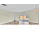 Open living room with sliding glass doors to patio and wood-look flooring at 1402 Tallahassee Dr, Tarpon Springs, FL 34689