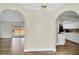 A view of an open floor plan showcasing a living room flowing into a kitchen at 1402 Tallahassee Dr, Tarpon Springs, FL 34689