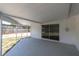 Enclosed patio with a concrete floor and a sliding glass door at 1402 Tallahassee Dr, Tarpon Springs, FL 34689