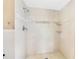 Step-in shower featuring white tiled walls and in-wall shelving niches at 1402 Tallahassee Dr, Tarpon Springs, FL 34689