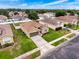 Aerial view of a charming home with a well-manicured lawn and driveway at 15205 Durango Cir, Brooksville, FL 34604