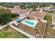 Aerial view of the backyard with pool, covered patio, fenced yard, and shade sails at 15205 Durango Cir, Brooksville, FL 34604
