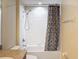 Clean bathroom with white tiled shower and fun banana-themed curtain at 15205 Durango Cir, Brooksville, FL 34604