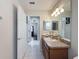 Bright bathroom with a large mirror, vanity, and tiled floor at 15205 Durango Cir, Brooksville, FL 34604