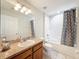 Well-lit bathroom featuring a vanity, toilet, and shower with a fun banana-themed curtain at 15205 Durango Cir, Brooksville, FL 34604