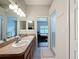 This bathroom features a double sink vanity and a walk-in shower, connecting to a bedroom at 15205 Durango Cir, Brooksville, FL 34604