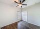 Bright bedroom featuring hardwood floors, ceiling fan, and closet at 15205 Durango Cir, Brooksville, FL 34604