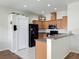 Well-lit kitchen featuring ample cabinet space, stainless steel appliances, and a functional breakfast bar at 15205 Durango Cir, Brooksville, FL 34604