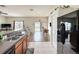 Kitchen view with a breakfast bar, and an adjacent dining and living area with a pool view through glass doors at 15205 Durango Cir, Brooksville, FL 34604