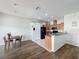 Bright kitchen area with hardwood floors, black appliances, and a breakfast bar, ideal for casual dining at 15205 Durango Cir, Brooksville, FL 34604