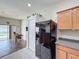 Kitchen featuring modern appliances and a view of the dining area and a pool through a sliding glass door at 15205 Durango Cir, Brooksville, FL 34604