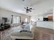 A well-lit living room with hardwood floors, ceiling fan, and sliding glass doors leading to the outside at 15205 Durango Cir, Brooksville, FL 34604