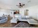 Open-concept living room with hardwood floors, ceiling fan, and a view into the kitchen and dining area at 15205 Durango Cir, Brooksville, FL 34604