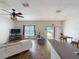 Inviting living room with wood flooring, ceiling fan, and sliding glass door to the outdoor space at 15205 Durango Cir, Brooksville, FL 34604