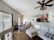 Spacious living room features an open layout, hardwood floors, and a ceiling fan with light fixture at 15205 Durango Cir, Brooksville, FL 34604