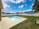 This backyard features a pool with lounge chairs, ideal for outdoor relaxation and entertaining at 15205 Durango Cir, Brooksville, FL 34604