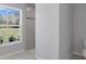 Bathroom featuring a walk-in shower with gray stone tile and a window overlooking the outdoors at 15291 Green Jay Rd, Weeki Wachee, FL 34614