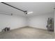 Spacious garage with concrete flooring, bright lighting and a utility closet at 15291 Green Jay Rd, Weeki Wachee, FL 34614