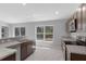 Spacious kitchen featuring stainless appliances, stone countertops, a breakfast bar and plenty of lighting at 15291 Green Jay Rd, Weeki Wachee, FL 34614