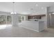 Open concept kitchen featuring recessed lighting, tile floors, a breakfast bar, and dark wood cabinets at 15291 Green Jay Rd, Weeki Wachee, FL 34614