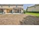 Backyard view featuring a screened lanai and green space at 15846 Stable Run Dr, Spring Hill, FL 34610