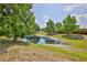 Natural pond in a backyard setting with trees at 15846 Stable Run Dr, Spring Hill, FL 34610