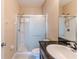 Bathroom featuring a walk-in shower with sliding doors and a sleek vanity with granite countertops at 15846 Stable Run Dr, Spring Hill, FL 34610
