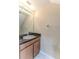 Bathroom features a vanity with granite countertop, a mirror, and wood cabinets at 15846 Stable Run Dr, Spring Hill, FL 34610