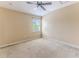 Carpeted bedroom with a ceiling fan, neutral walls, one window with blinds, and multiple electrical outlets at 15846 Stable Run Dr, Spring Hill, FL 34610