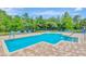 Community pool featuring a large, well-maintained pool deck with plenty of seating and a clear blue pool at 15846 Stable Run Dr, Spring Hill, FL 34610