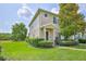 Charming townhouse featuring a well-maintained lawn, manicured bushes, and a welcoming front entrance at 15846 Stable Run Dr, Spring Hill, FL 34610
