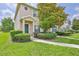 Charming townhome featuring a well-manicured front yard and a covered porch entryway at 15846 Stable Run Dr, Spring Hill, FL 34610
