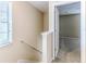 Hallway features neutral walls, white trim, a window with blinds, and a doorway leading into a carpeted room at 15846 Stable Run Dr, Spring Hill, FL 34610